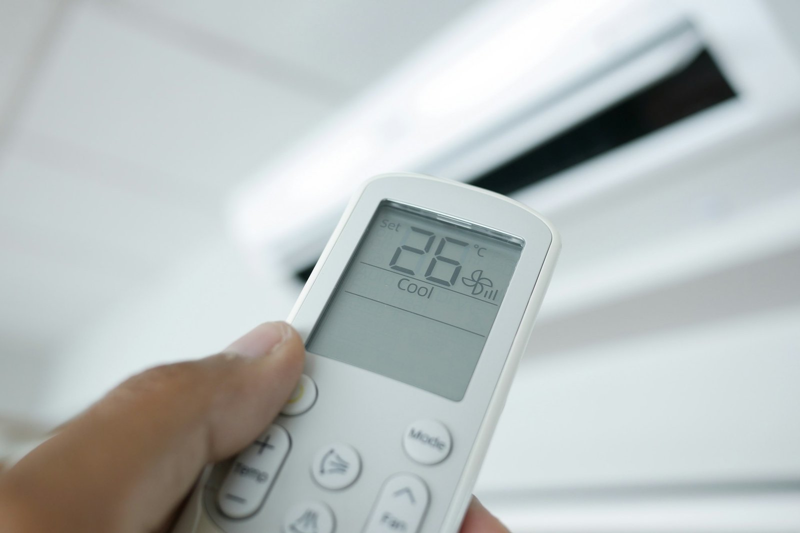 Close up of man hand holding air condition remote.