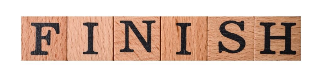 The inscription finish on wooden cubes on a dark concrete background